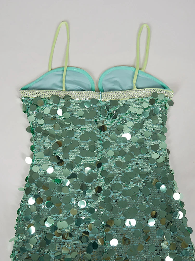 Green sequin dress with thin straps on a light gray background