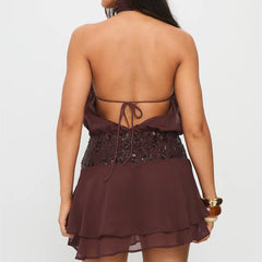 Brown dress with sequin details on a plain background