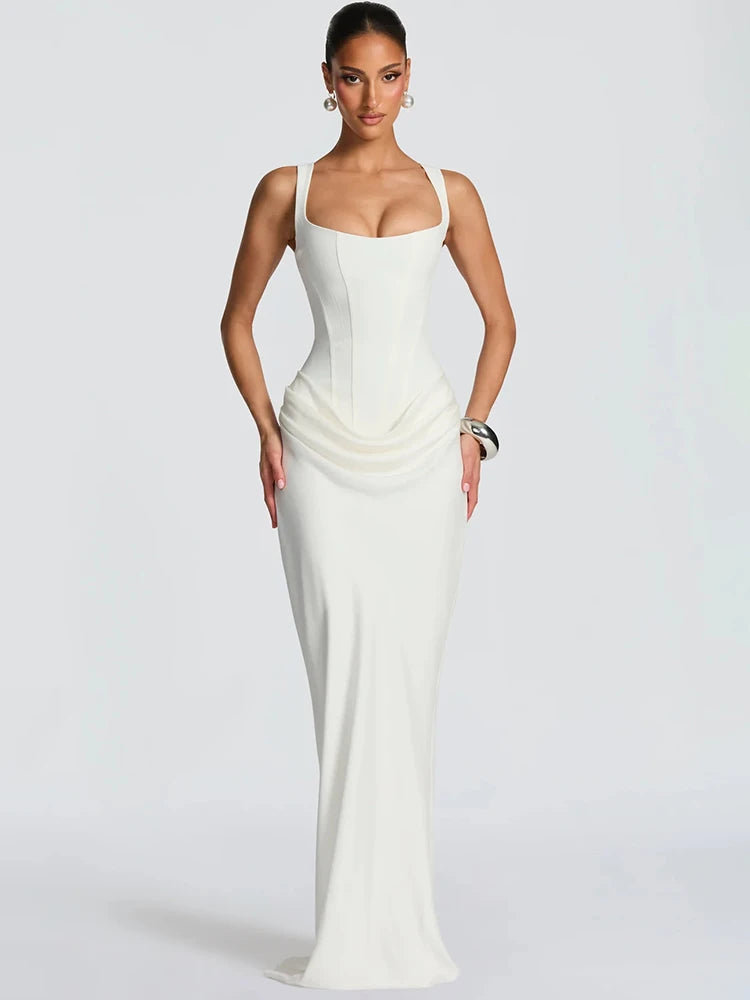 Woman wearing a white evening gown on a plain background