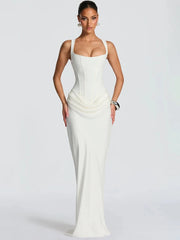Woman wearing a white evening gown on a plain background