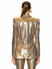 Gold sequin blazer worn by a person on a white background