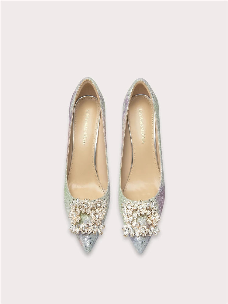 Pair of embellished high-heeled shoes on a light gray background