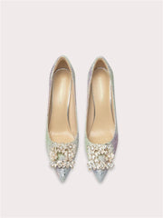Pair of embellished high-heeled shoes on a light gray background