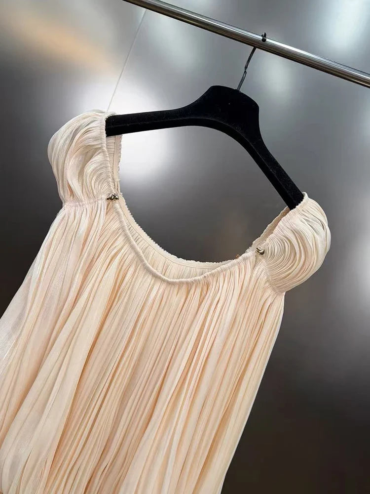 Beige dress on a black hanger against a dark background