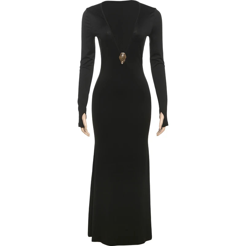 Black evening gown with long sleeves and a decorative brooch on a white background