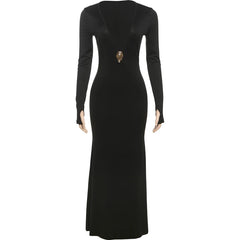 Black evening gown with long sleeves and a decorative brooch on a white background