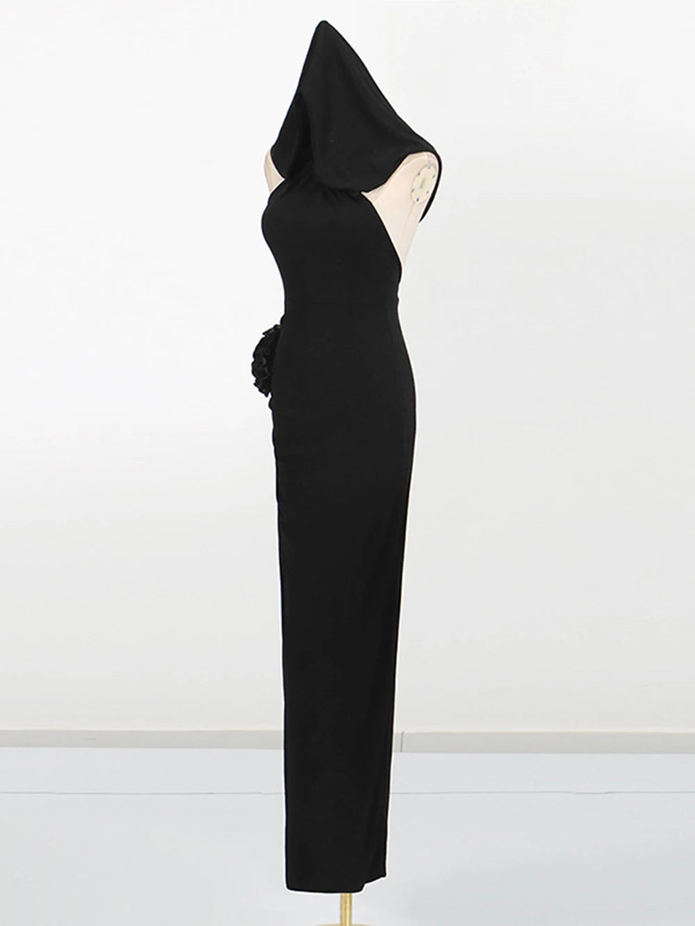 Black hooded dress on a mannequin against a white background