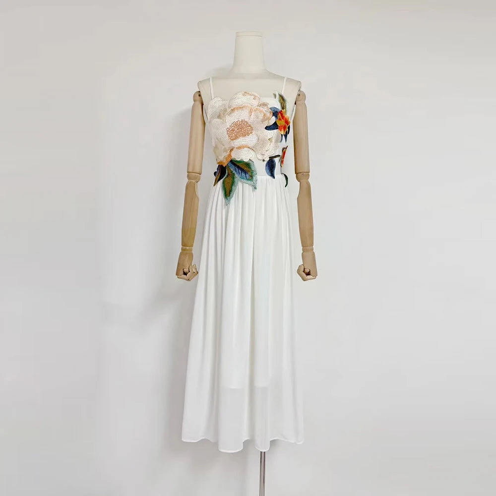White dress with floral embroidery on a mannequin against a white background
