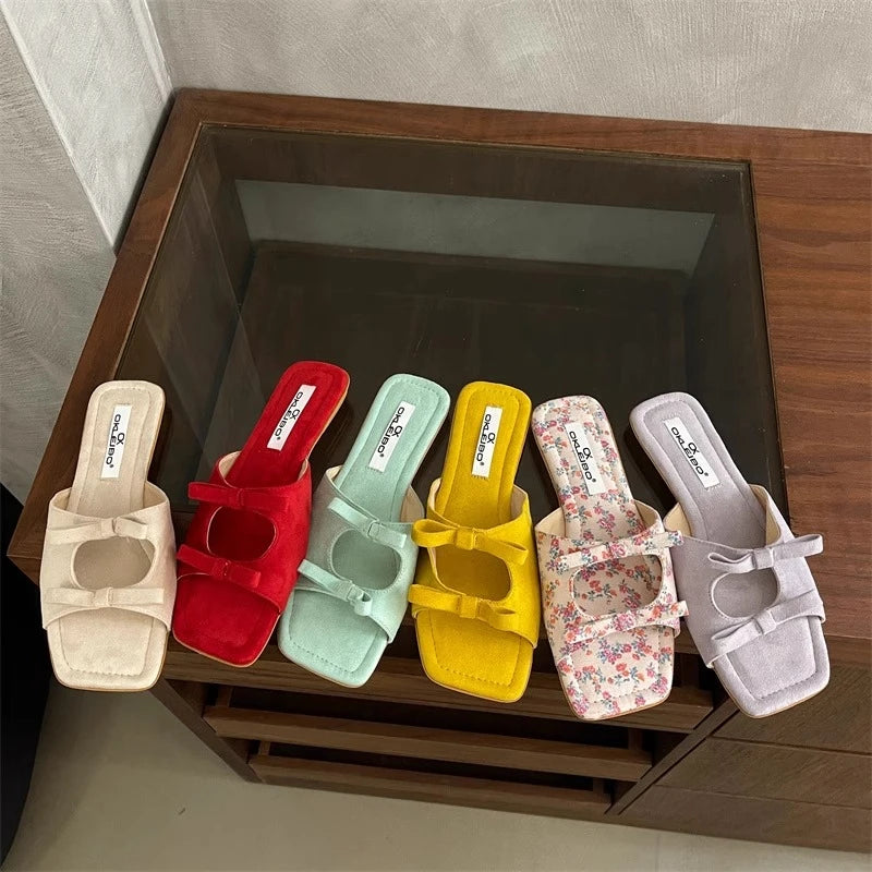 Set of colorful slides with floral pattern on a wooden surface