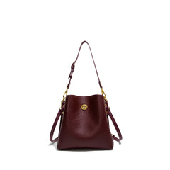 Brown leather handbag with gold accents on a white background
