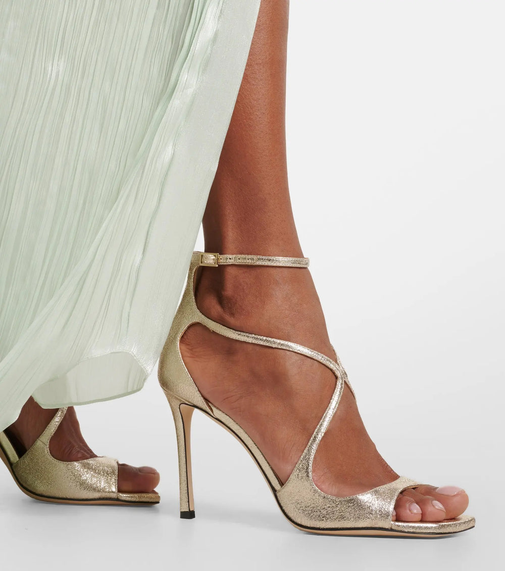Model wearing gold ankle strap stiletto sandal