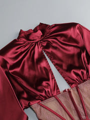 Red satin garment with sheer lining on a light gray background