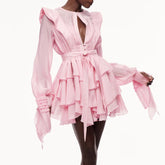 Pink ruffled dress on a white background
