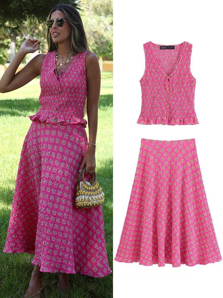 Woman wearing a pink dress with a matching top and skirt, standing outdoors.