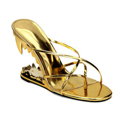 Gold high-heeled sandal with studded detail on a white background