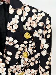 Detail of gold buttons on redcurrant print blazer