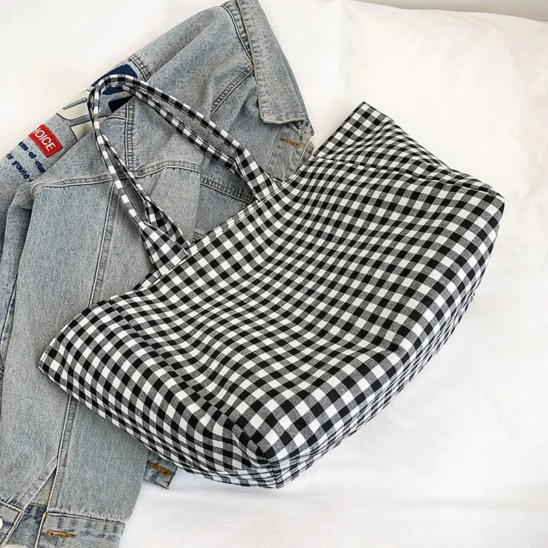 Black and white checkered dress with denim jacket on a light background