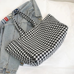 Black and white checkered dress with denim jacket on a light background