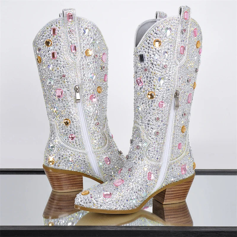 Sparkling cowboy boots with rhinestones on a reflective surface