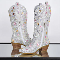 Sparkling cowboy boots with rhinestones on a reflective surface