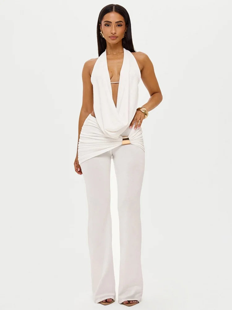 Woman wearing a white sleeveless top and pants on a white background