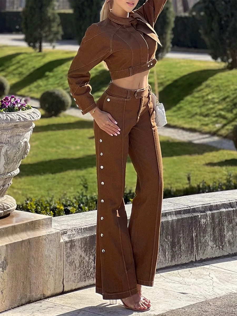 Woman wearing a brown outfit with a matching top and pants in an outdoor setting.