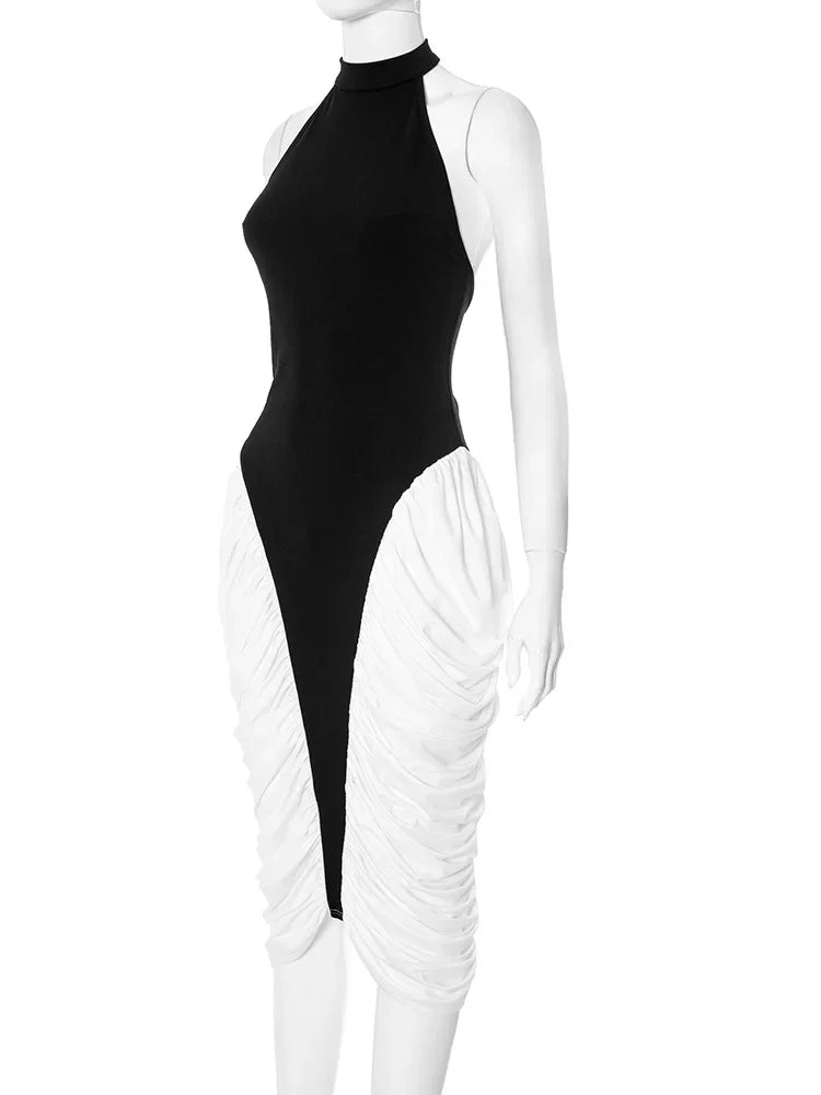 Mannequin wearing a black and white outfit with a high neckline and ruched white pants