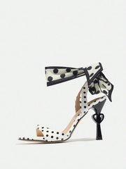 Polka dot sandal with heart design on a white background