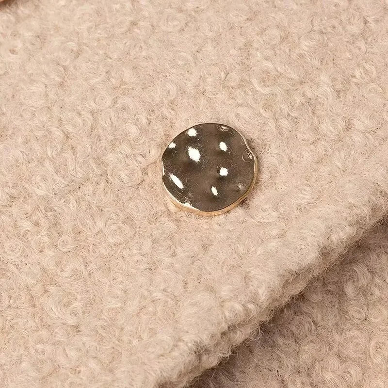 Close-up of a button on beige fabric