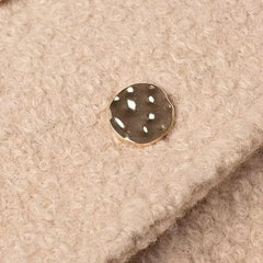 Close-up of a button on beige fabric