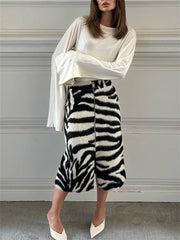 Model wearing zebra print midi skirt with white top