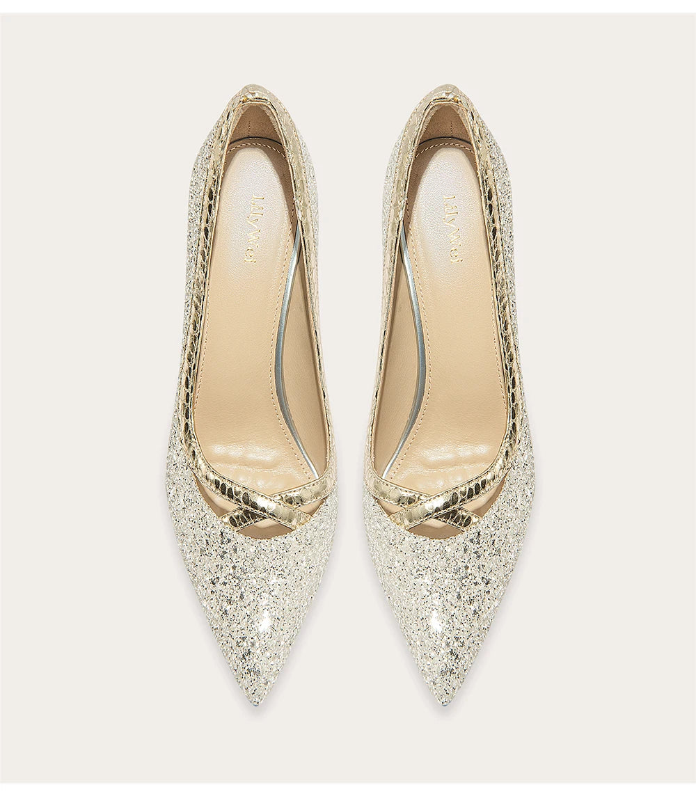 Pair of glittery gold high heels on a white background
