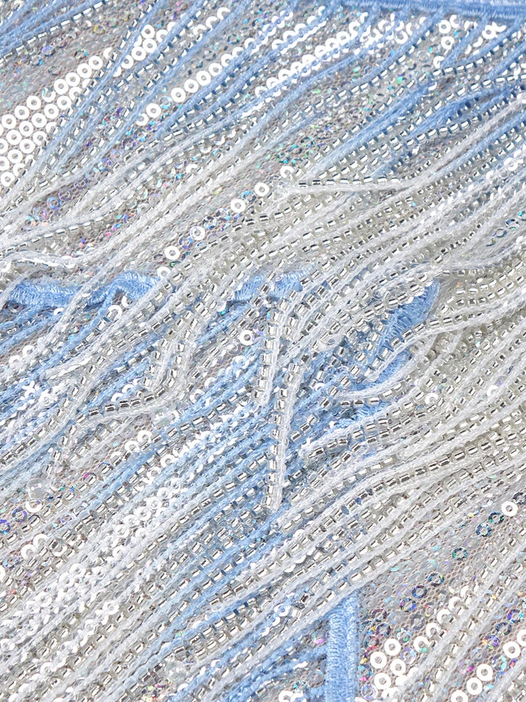 Close-up of a textured fabric with blue and silver sequins