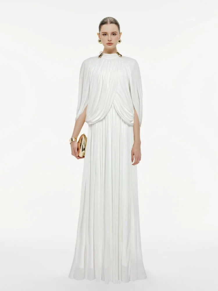 Woman wearing a white flowing dress on a white background