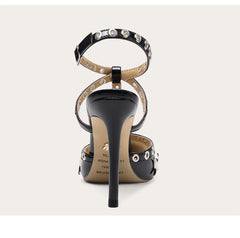 Black high-heeled sandal with studded details on a white background