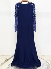 Navy blue evening gown with floral embellishments on a white background