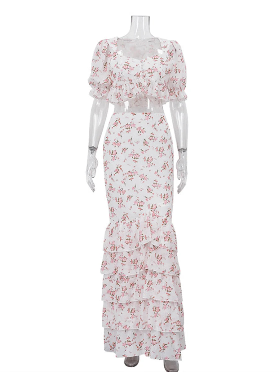 Mannequin displaying a floral print puff sleeve crop top and ruffle maxi skirt.