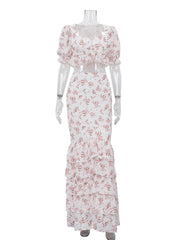 Mannequin displaying a floral print puff sleeve crop top and ruffle maxi skirt.