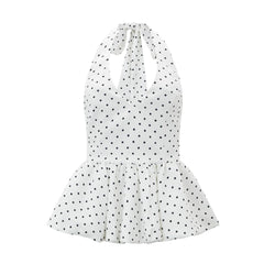 White halter neck dress with black polka dots on a white background