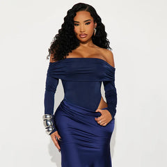 Woman wearing a blue off-shoulder dress against a white background