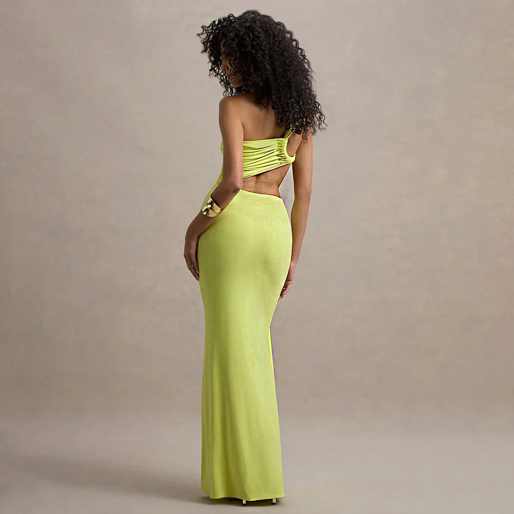 Woman wearing a bright green evening gown against a beige background