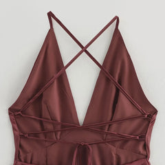 Maroon halter top with criss-cross straps on a light gray background