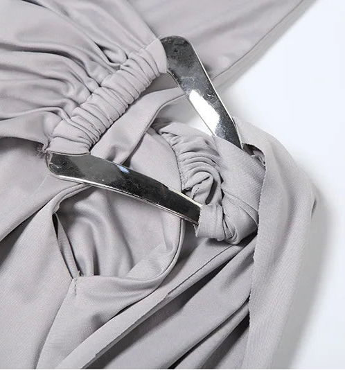 Close-up of a gray fabric with a metal buckle on a white background