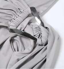 Close-up of a gray fabric with a metal buckle on a white background
