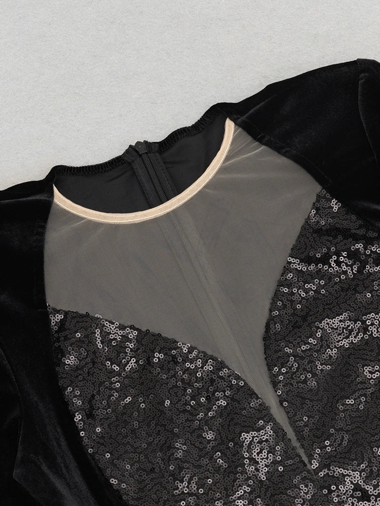 Black dress with sequin detailing on a light gray background