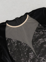 Black dress with sequin detailing on a light gray background