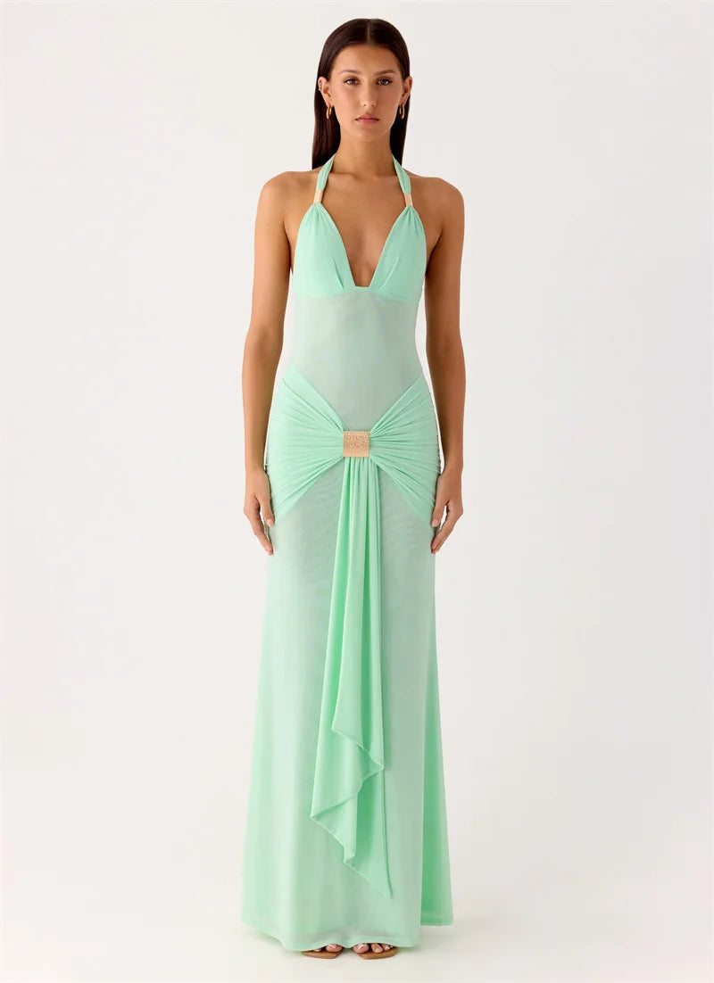 Woman wearing a mint green evening gown on a white background