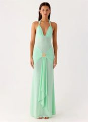 Woman wearing a mint green evening gown on a white background