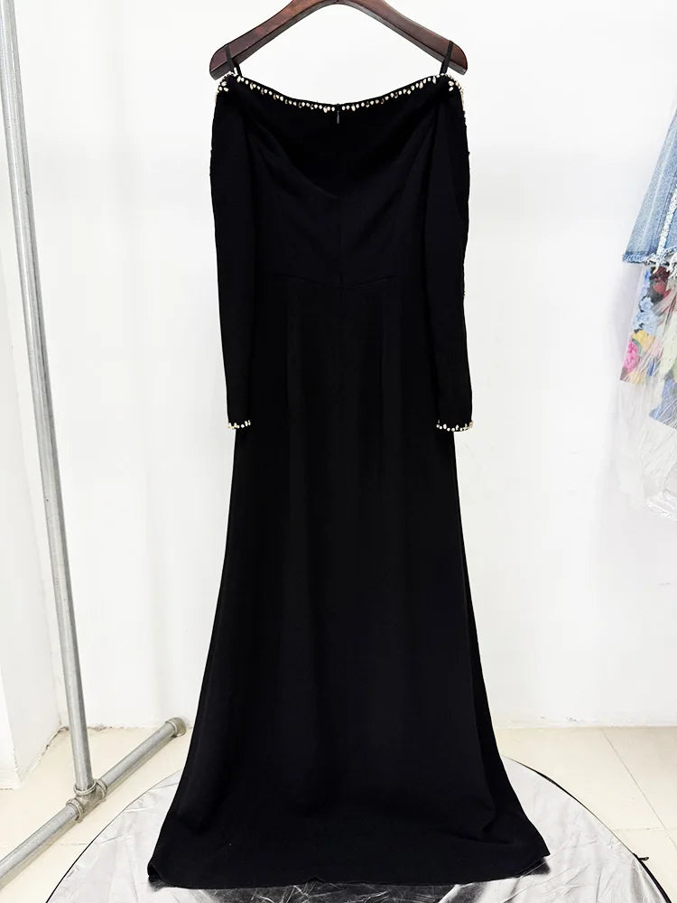 Back view of a black long sleeve maxi dress with beaded trim.