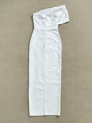 White off-shoulder dress on a beige background